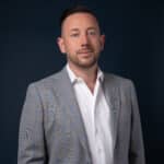 Jordan Barber in a white shirt and blazer